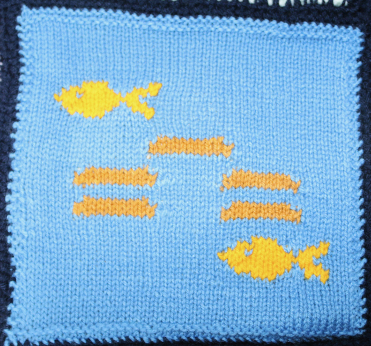 Knitted square: 5 loaves and 2 fishes