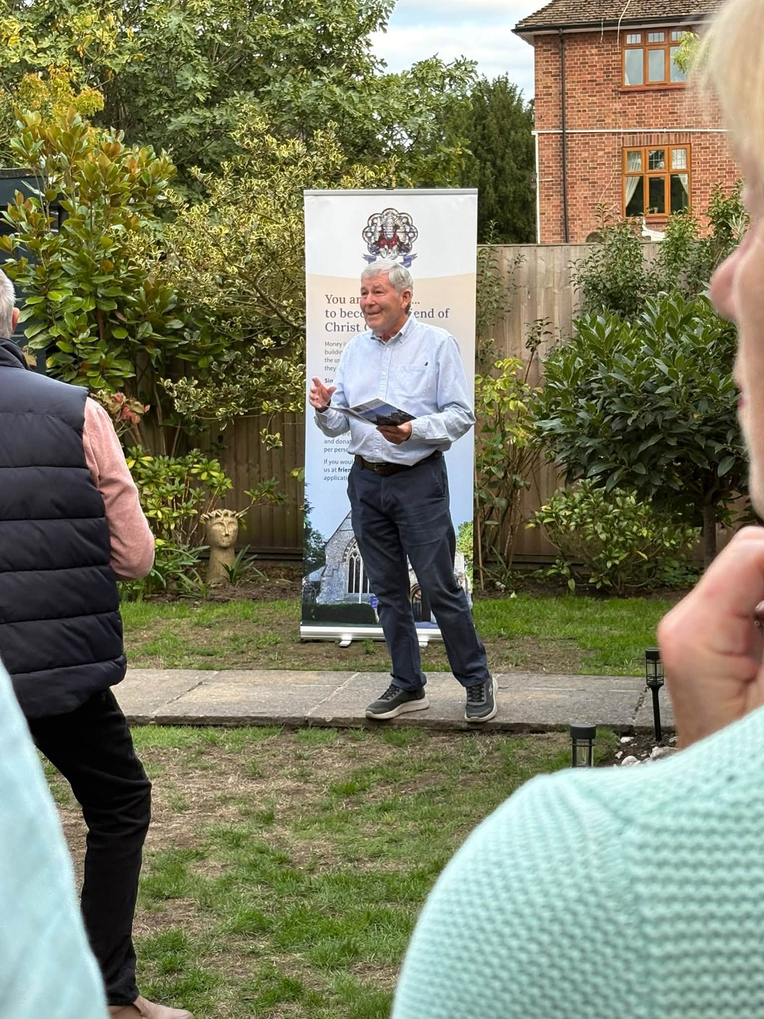 David Scott talking to members of The Friends in his garden