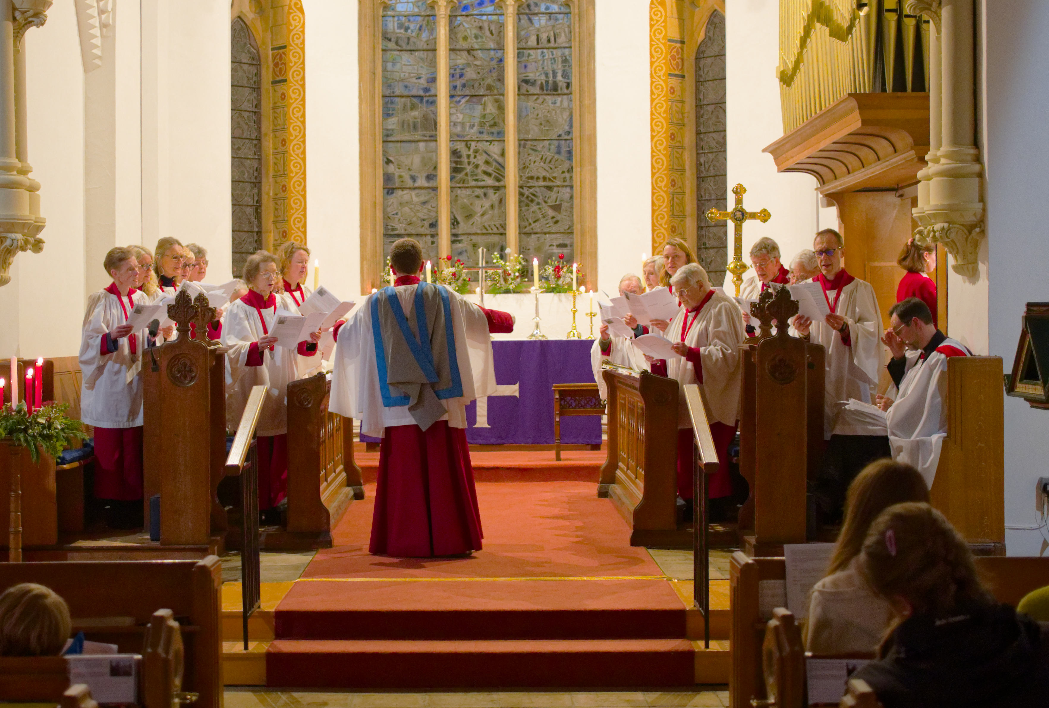 Matt conducting the choir during the 2025 Carol Service