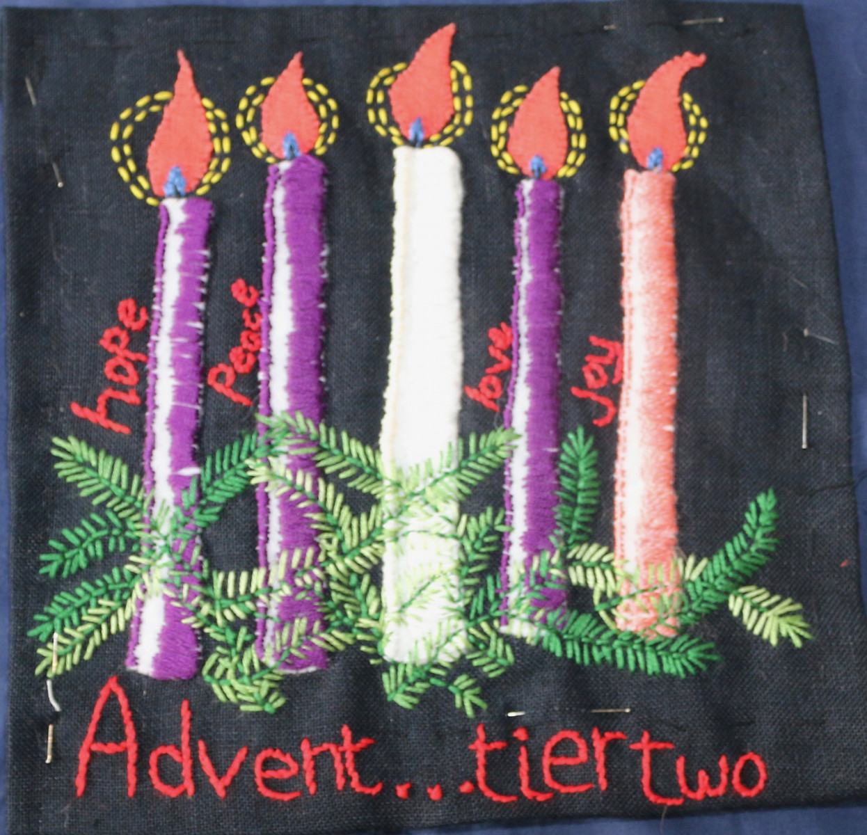 Embroidery of a fully lit Advent wreath