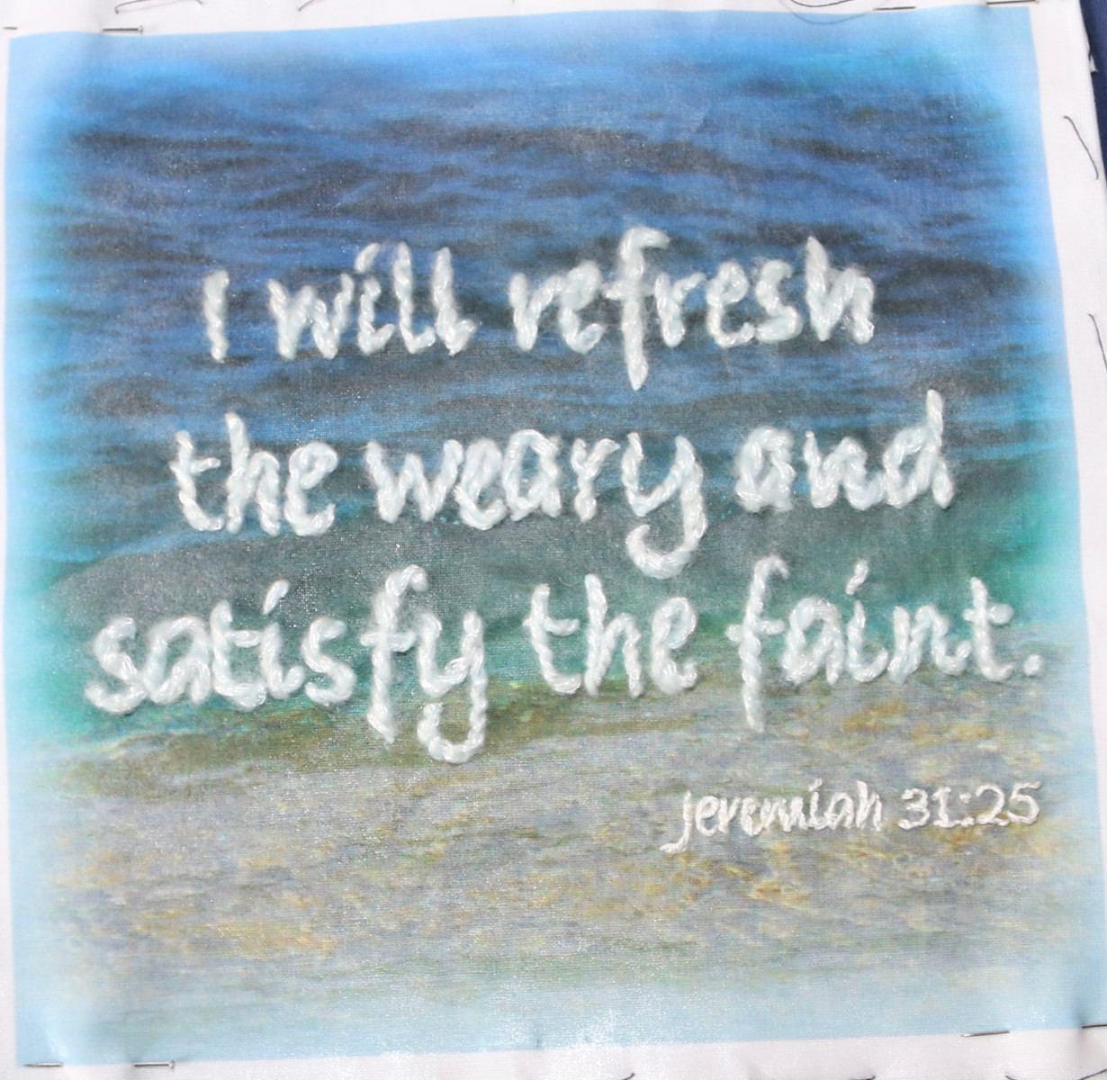Embroidery of Jeremiah 31vs25 on image of the sea
