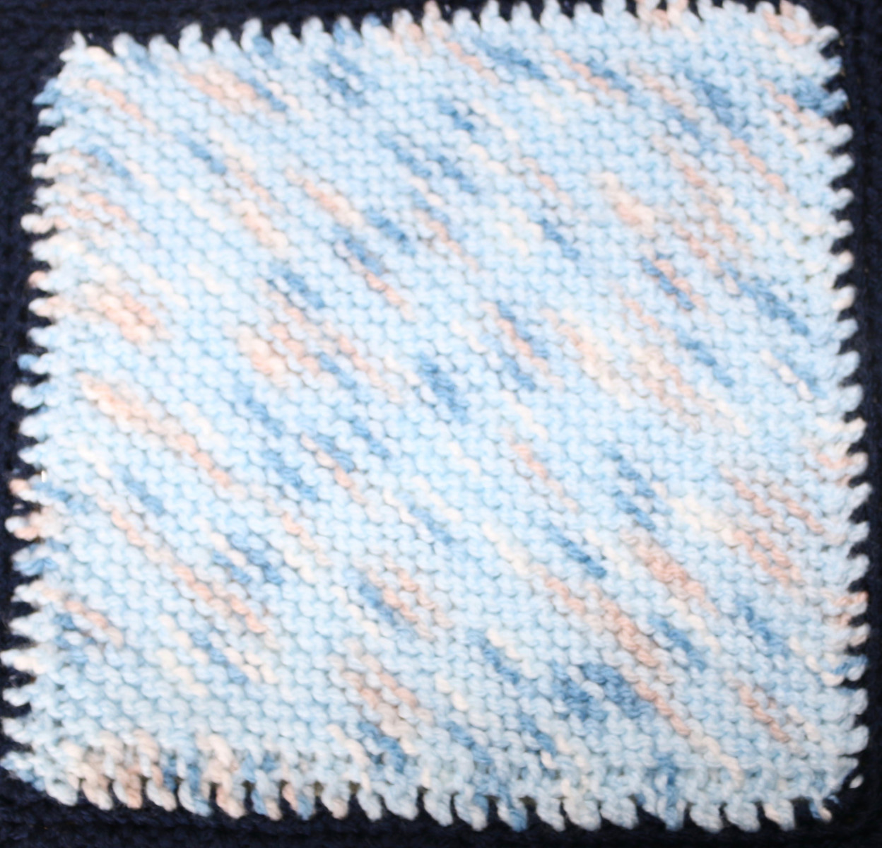 Blue, pink and white knitted square