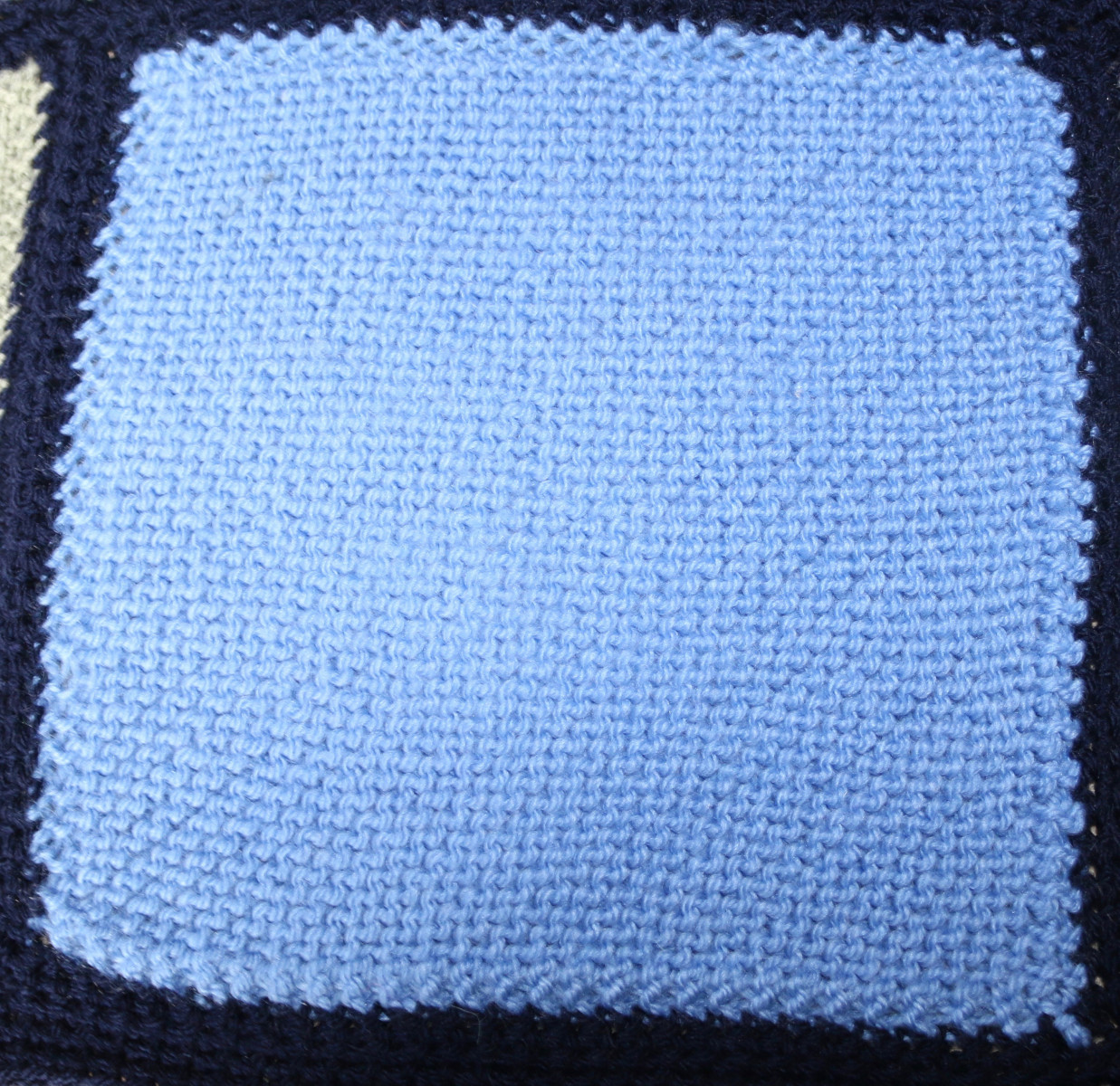 Pale blue knitted square