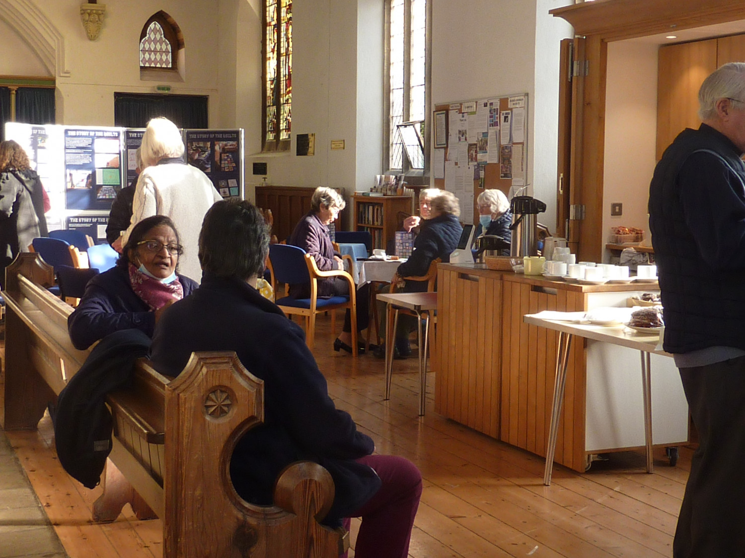 People sitting having refreshments in a church