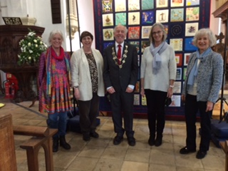 Mayor of Norwich and quilt makers in front of the textile quilt